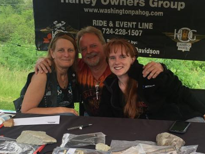 A man hugging a two ladies