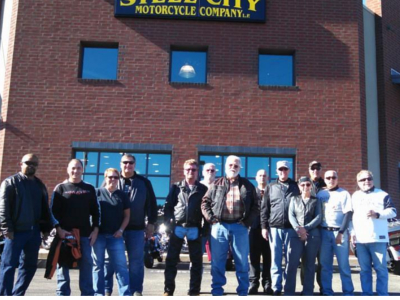Several men front the shop Steel City
